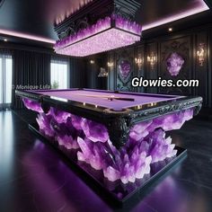 a pool table with purple flowers on it in front of a large chandelier