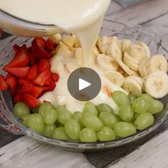 grapes, strawberries, bananas, and cream being poured into a bowl with fruit