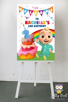 a sign that is on top of a easel with an image of a baby's first birthday cake