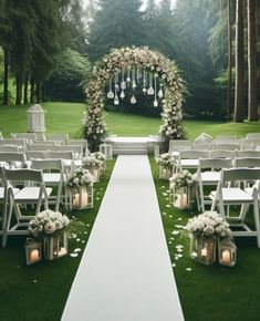 an outdoor ceremony setup with white flowers and candles