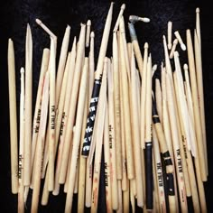 several baseball bats are lined up on a black surface