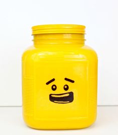 a yellow jar with a face drawn on it