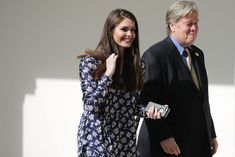 a woman walking next to an older man in a suit and tie on the street