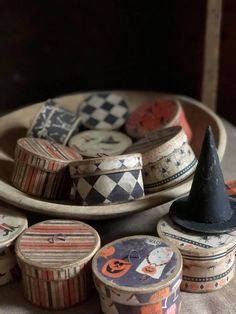 an assortment of decorative wooden boxes on a table with a witches hat in the middle