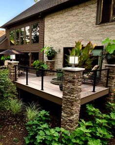 a house that has some plants on the front porch and steps leading up to it