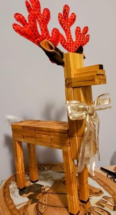 a chair made out of wood with red corals on it