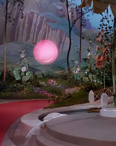 an artistic scene with flowers and plants in the foreground, pink light coming from behind