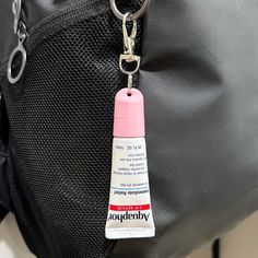 a close up of a bag with a small tube of glue on the front pocket