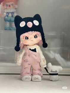 a little doll with a cat hat on