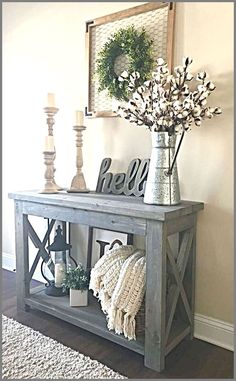 a wooden shelf with flowers and candles on it