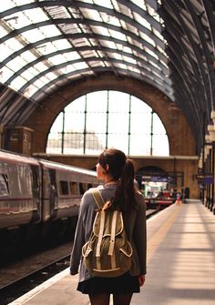 a woman with a backpack standing in front of a train at a subway station while text reads, follow for follow hipster india