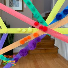 a group of colorful sticks with pom poms on them