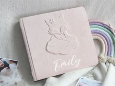 a pink book with the word family written on it next to photos and other items