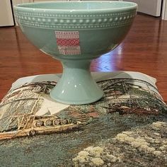 a blue bowl sitting on top of a rug