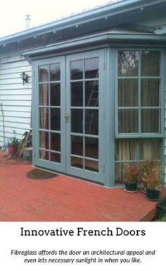 a patio with sliding glass doors and potted plants on the side of the house