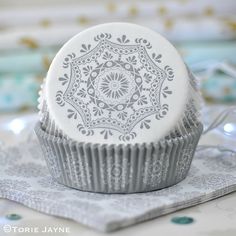 a white cupcake sitting on top of a table