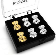 four pairs of gold and silver cufflinks in a black box with the name anchora on it