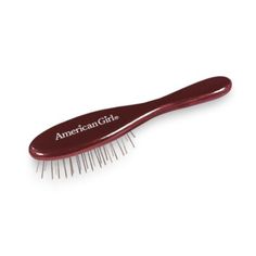 an american girl hair brush on a white background