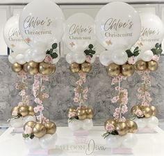 some white and gold balloons with flowers on them