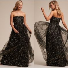 Step Into A Starlit Dream With This Joanna August Strapless Maxi Dress. The Ethereal Gold Stars Shimmer Against The Black Tulle, Creating A Celestial Ballet With Every Movement. Crafted Meticulously, The Dress Ensures You Radiate Elegance At Any Formal Event. Let Your Inner Star Shine Brightly. Color: Black / Gold Strapless Design Black Tulle With Gold Star Details Side Zipper Closure Maxi Length Fully Lined Approximate Measurements Taken While Lying Flat: Length: 56" Waist 13.5" Pit To Pit: 15" Tulle Prom Dress Black, Celestial Dress, Prom Dress Black, Gown Gold, Bhldn Dress, Tulle Maxi Dress, Black Tulle, Black Tie Wedding, Strapless Maxi Dress