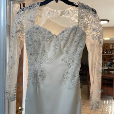 a wedding dress hanging on a hanger