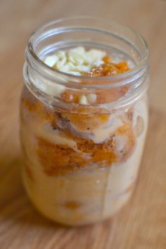 a jar filled with food sitting on top of a wooden table