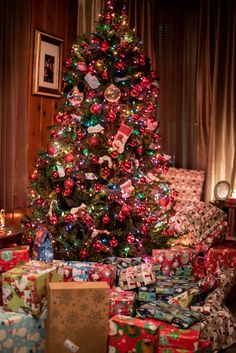 a christmas tree with presents under it