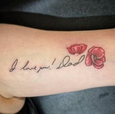 a woman's arm with flowers and the words i love you dad on it