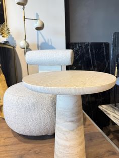 two white stools sitting on top of a wooden table