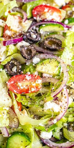 a salad with olives, tomatoes, onions and feta cheese