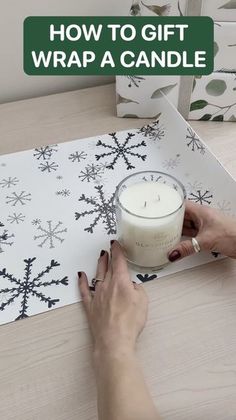 a person is wrapping a candle on a table