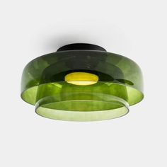 a green and black light fixture hanging from the ceiling