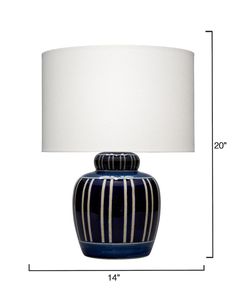 a large blue and white striped lamp with a white shade on the bottom half of it