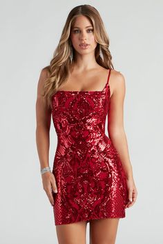 a woman wearing a red sequinned dress with spaghetti straps and thigh high heels