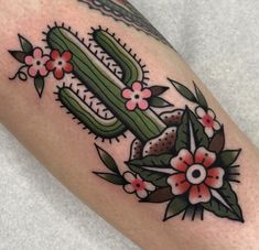 a cactus with flowers and leaves on the leg