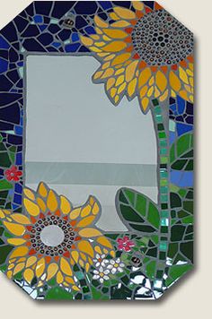 a stained glass mirror with sunflowers on it