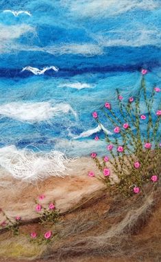 a painting of pink flowers growing out of the sand