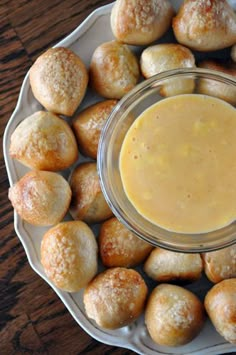 a plate topped with rolls and dipping sauce