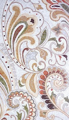 a close up view of an artistic design on the surface of a mosaic tile wall