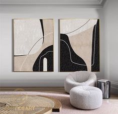 two abstract paintings hang on the wall above a round coffee table in a modern living room