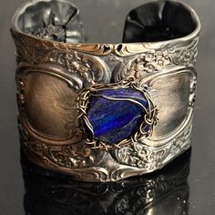 Thanks For Looking At This Handmade One Of A Kind Cuff Bracelet Made With Antique Victorian Sterling Silver Gorham (Circa Early 1900's) This Is Gorham Buttercup, There Are Some Holes (Filagree?) , In The Sterling, But Nothing That Will Deter From The Structure So I Wire Wrapped Genuine Lapis To It With Solid Sterling Silver I Preserved This Stunning Antique. Saved From " Destruction Fits Large Wrists,6.5" -7.5" , Slightly Adjustable Tested Sterling Silver All Edges Are Smooth 2 Inches Wide 55.7 Unique Blue Nickel-free Cuff Bracelet, Adjustable Silver Fusion Cuff Bracelet, Adjustable Blue Engraved Cuff Bracelet, Elegant Blue Cuff Bracelet With Polished Finish, Adjustable Blue Jewelry In Wearable Art Style, Unique Blue Engraved Jewelry, Blue Wearable Art Bracelet, Artisan Blue Sterling Silver Bracelets, Artisan Blue Sterling Silver Bracelet