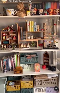 the shelves are filled with books, toys and other items in baskets on top of them