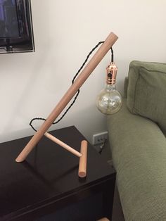 a lamp that is sitting on top of a table next to a couch and television