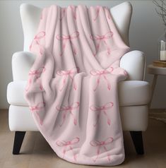 a white chair with a pink blanket on it