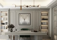 a white desk sitting under a painting on top of a book shelf in a room