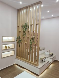 the interior of a store with wooden stairs and plants on display at the bottom floor