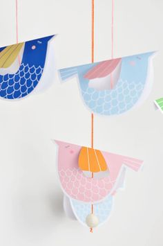 three colorful paper birds hanging from strings