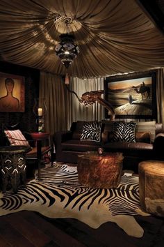 a living room with zebra print rugs on the floor and lights hanging from the ceiling