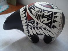 a black and white animal statue sitting on top of a table