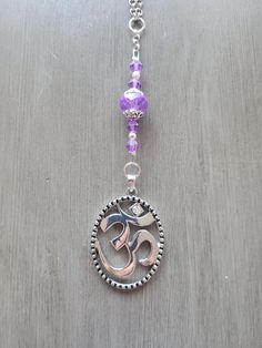 Delicate design Om symbol on 18" chain.  Let this necklace remind you to call in more serenity,  a peaceful mindset and a deeper connection to the spiritual each time you wear it. It's a symbol of the Sacred sound and helps create positive intentions.  Pieced by hand. Positive Intentions, Om Pendant, Purple Beads, Om Symbol, Symbol Necklace, Deeper Connection, Delicate Design, Name Necklaces, Name Necklace